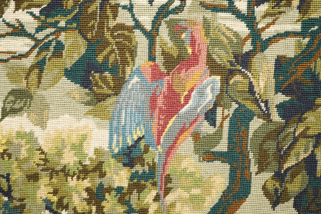 A large framed gross point wool work panel, designed in a verdure foliate palette as a classical French landscape. 161cm wide x 132 cm high.
